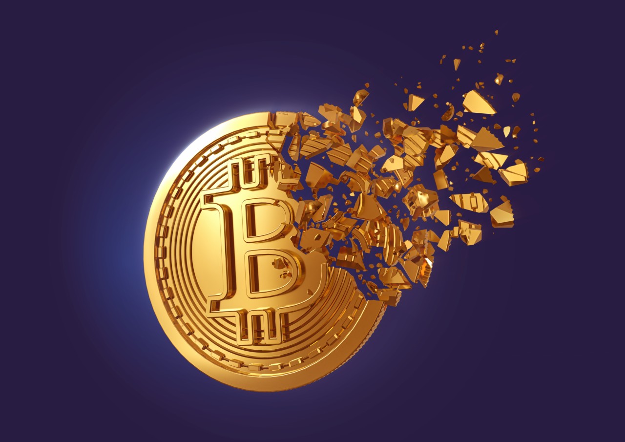 bitcoin graphic with coin breaking away in pieces