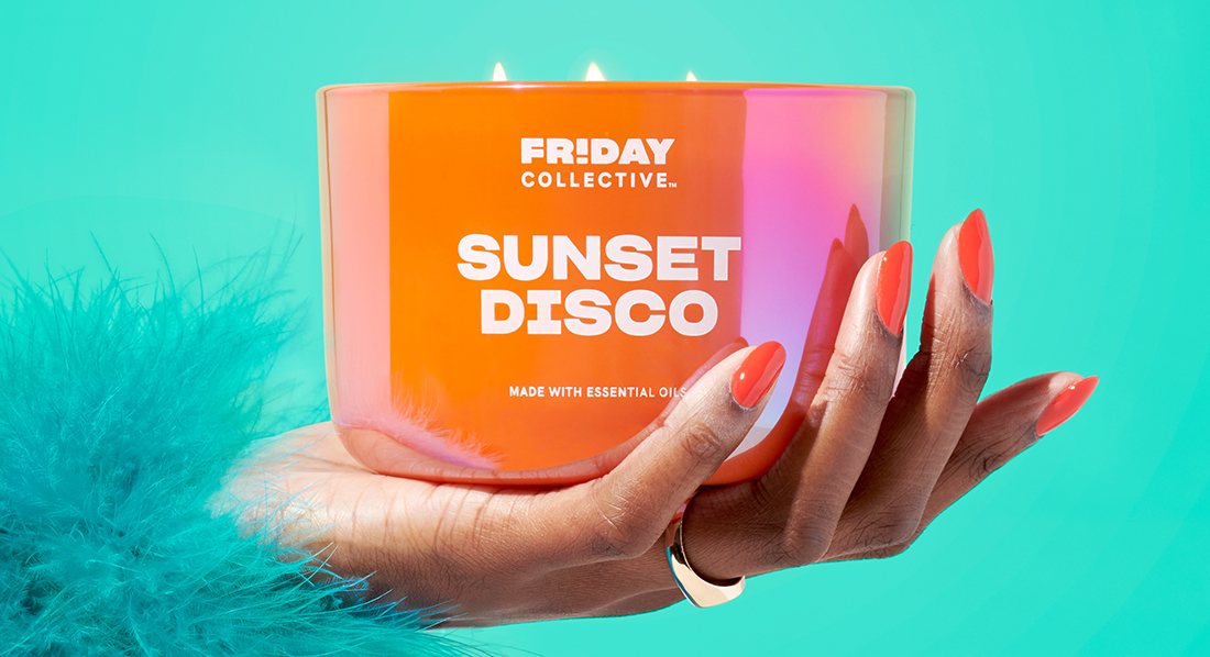Friday Collective Sunset Disco scented candle held in hand