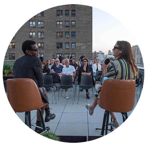 Two guests sitting in front of an audience