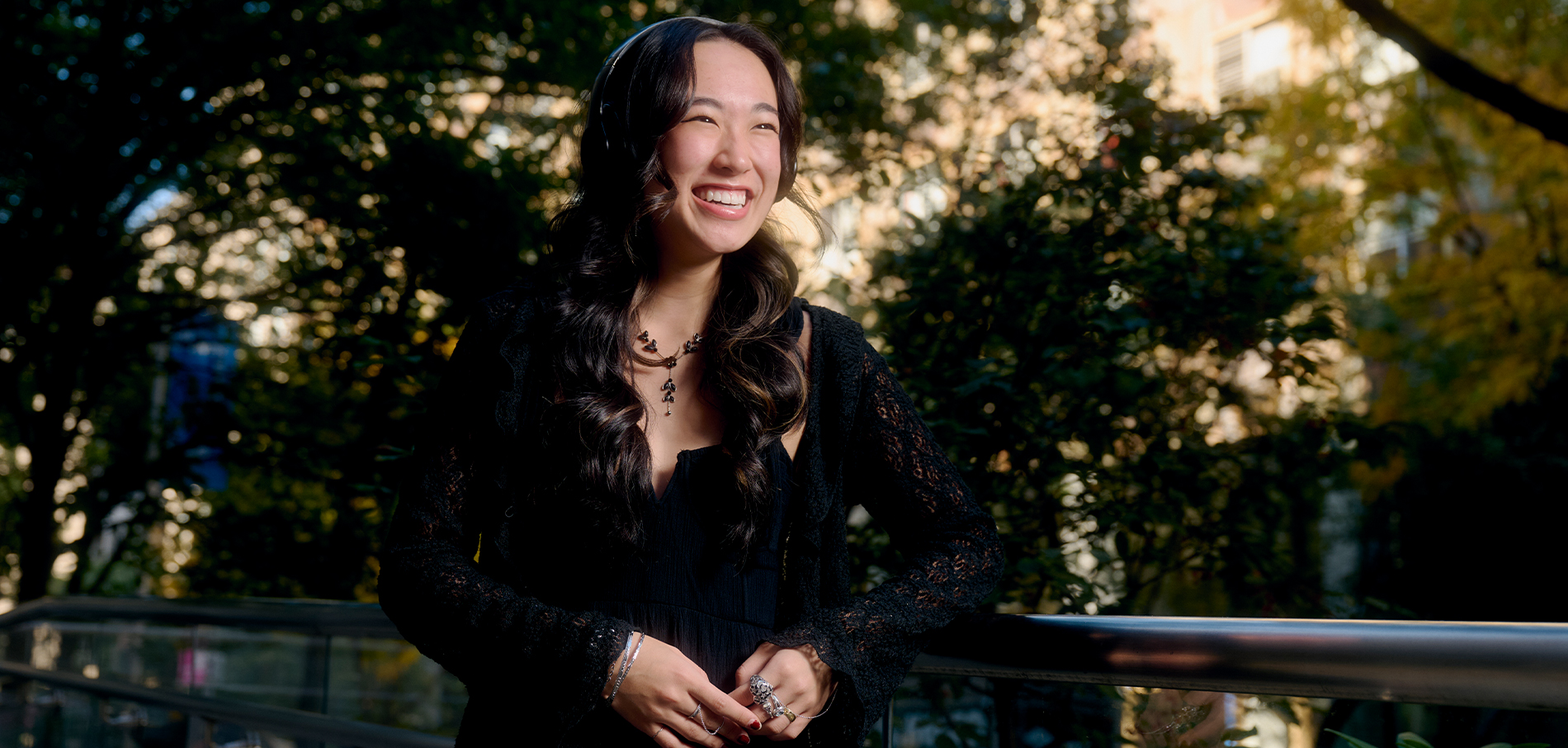 FIT student smiling sitting outside on campus