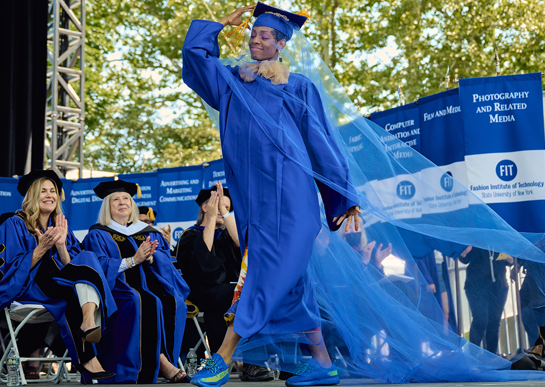 FIT student walking on commencement stage at Central Park