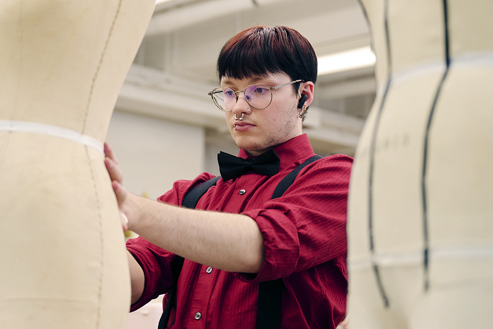 FIT fashion design student working with dress forms