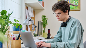 student in front of a laptop