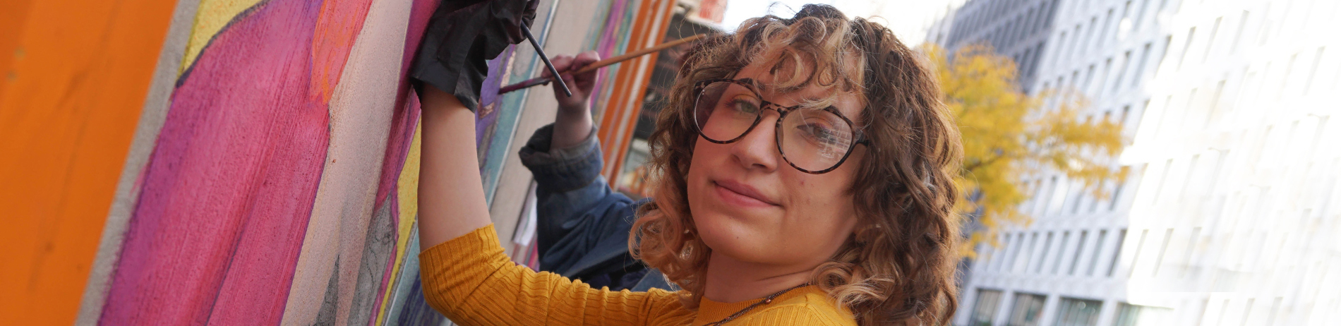 FIT illustration student working on the ChalkFIT walls project outdoors on campus