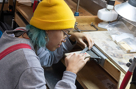 student making jewelry