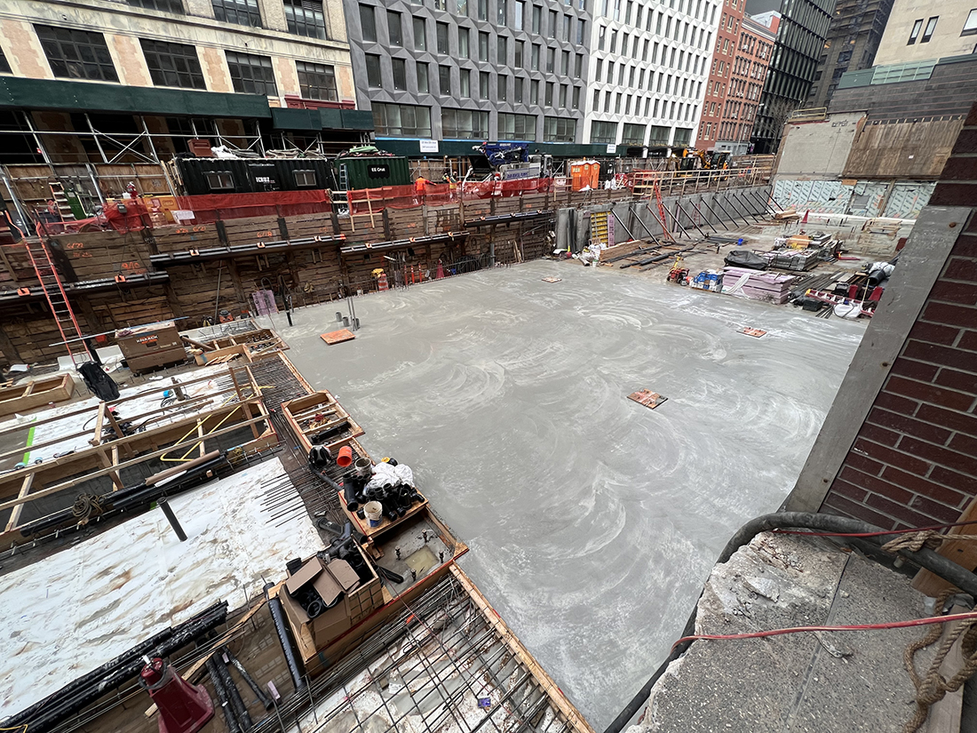 completed concrete pour over building foundation