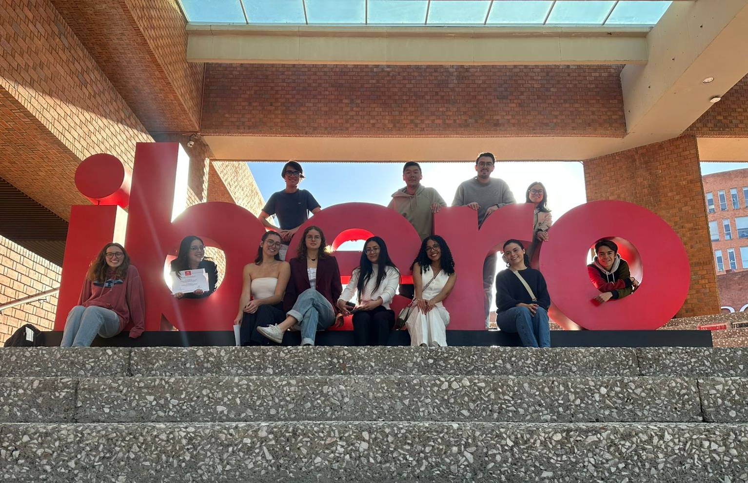 Students in front of Ibero sign