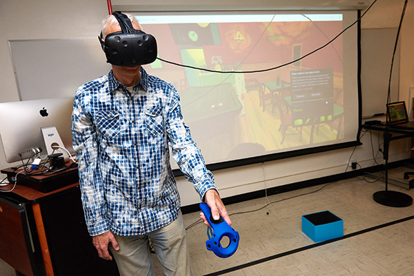 faculty member wearing virtual reality goggles