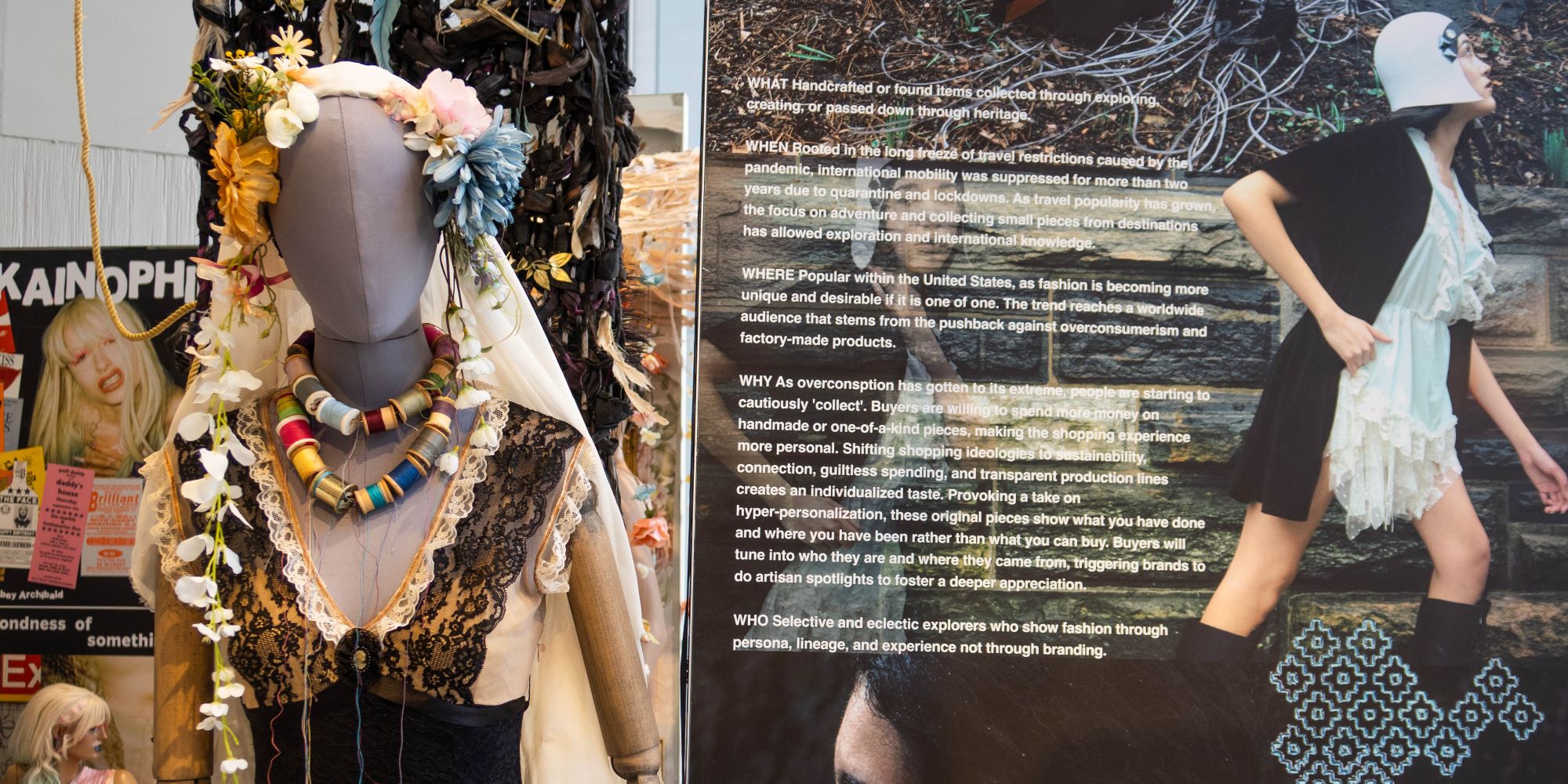 a female mannequin is dressed in a garment featuring flesh tones, black lace around the bust, and a form fitting bodice/skirt. Several necklaces made of sewing thread spools are placed around the neck, headdress is comprised of a long veil decorated with flowers. The isntallation features mood board made of images and texe convey the ideas.