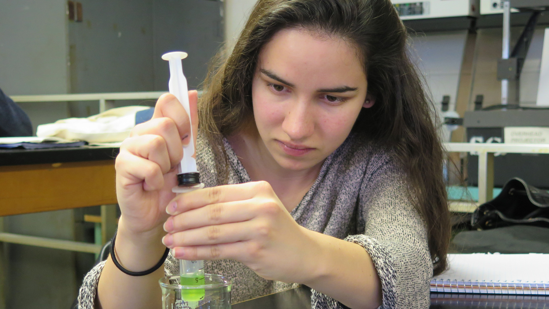 student using a syringe in a science lab
