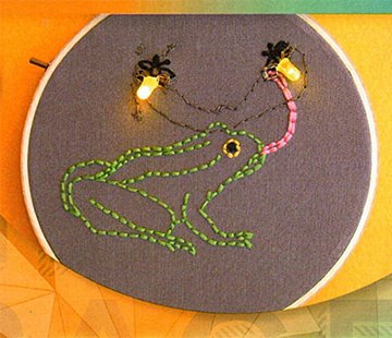 embroidery with sewn on lights powered by arduino lilypad