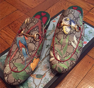 Brown fabric heelless loafers patterned with double-G logo and leaves, parrot and butterflies