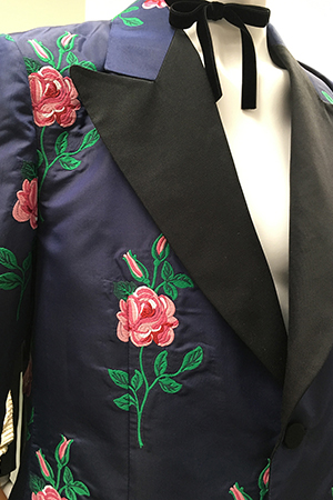 dark blue man's suit jacket embroidered with pink roses