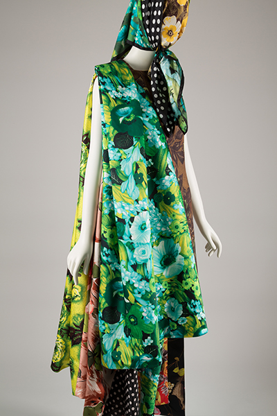 mannequin in at patterned floral and polka dot ensemble that includes a scarf covering the head