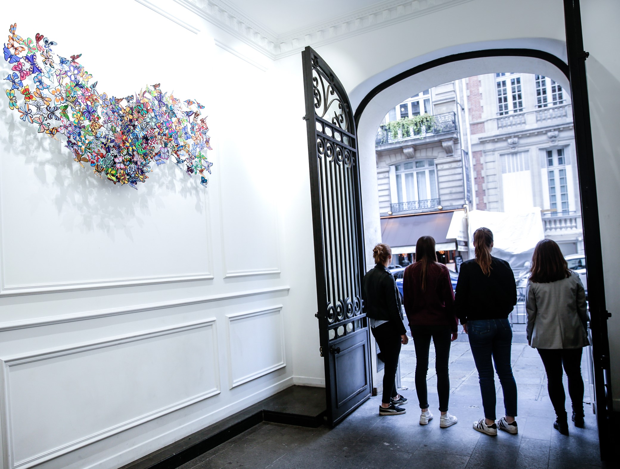 students standing in lobby of ICART looking out on the street