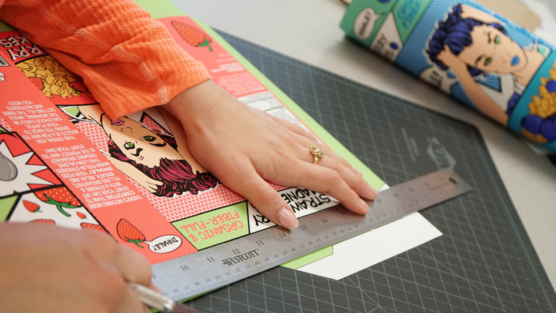 hands with ruler, measuring a piece of paper