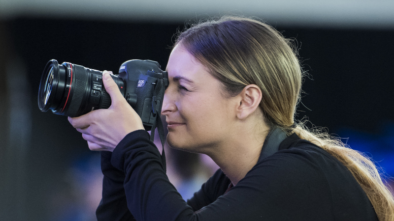 woman holding a camera up to her eye