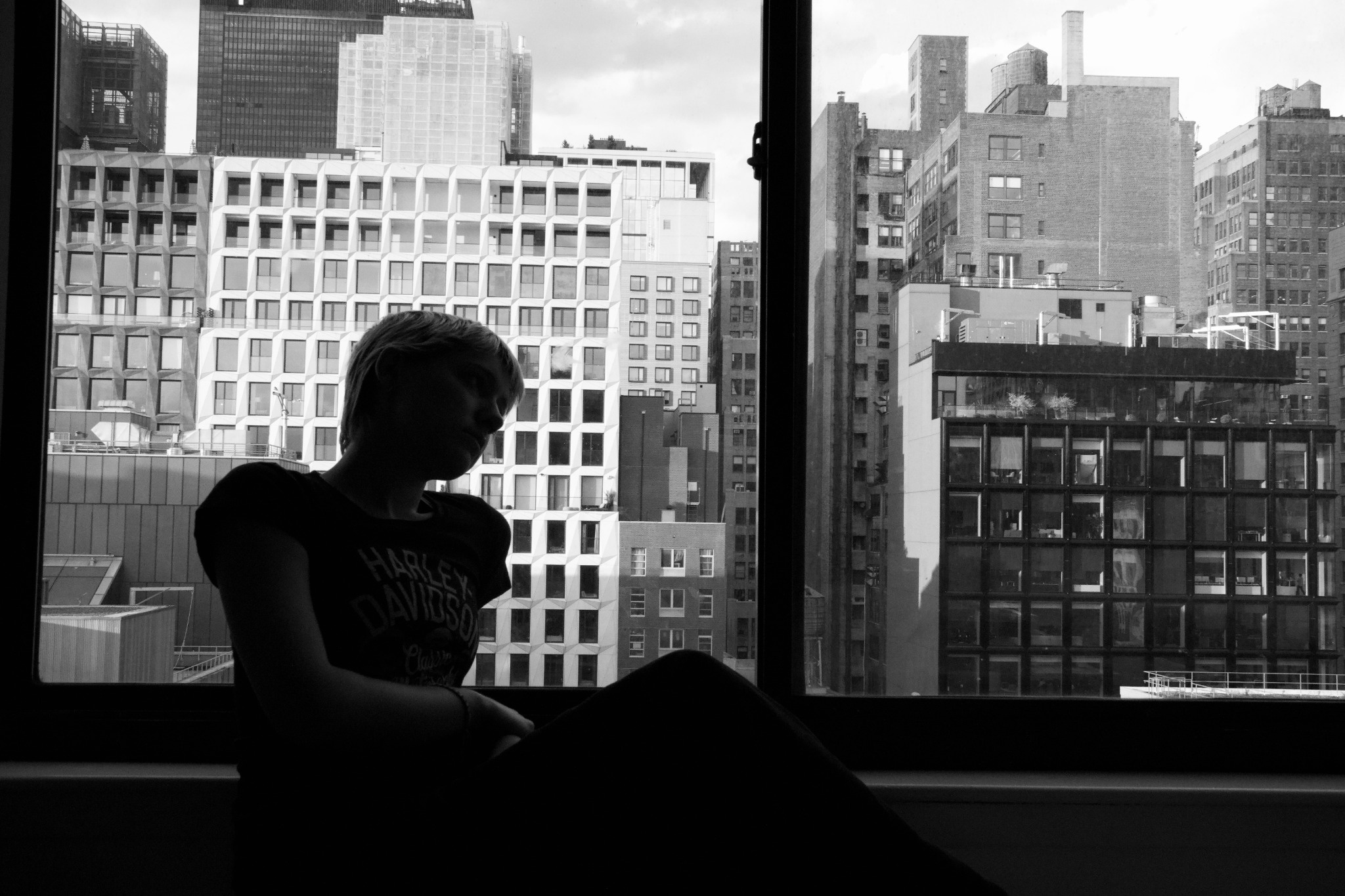 Student sitting in front a window overlooking New York skyline