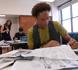 student drawing at a lab table