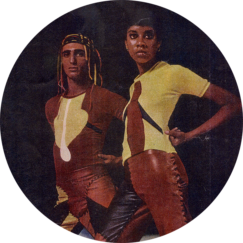 Two figures wearing Stephan Burrows ensembles in brown