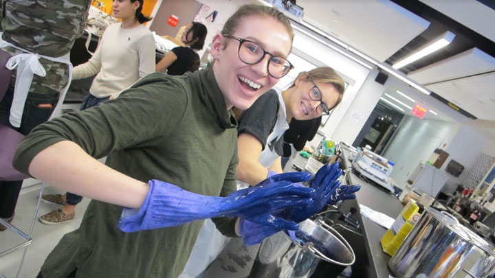 students wearing rubber gloves in the textile lab.