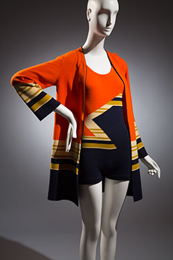 orange and navy swimsuit with off-white and green large zig-zag and strip patterns with matching jacket