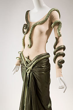nude and iridescent green ensemble with snake-like design across shoulders and chest