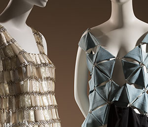 two mannequins with sleeveless dresses made from chain-linked pieces 