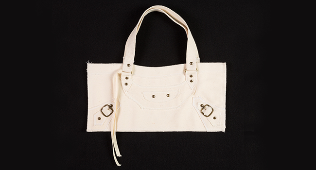 White purse with grommets and pocket