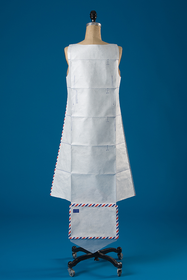 white sleeveless tyvek dress made from unfolded air mail envelope with red, white, blue trim 