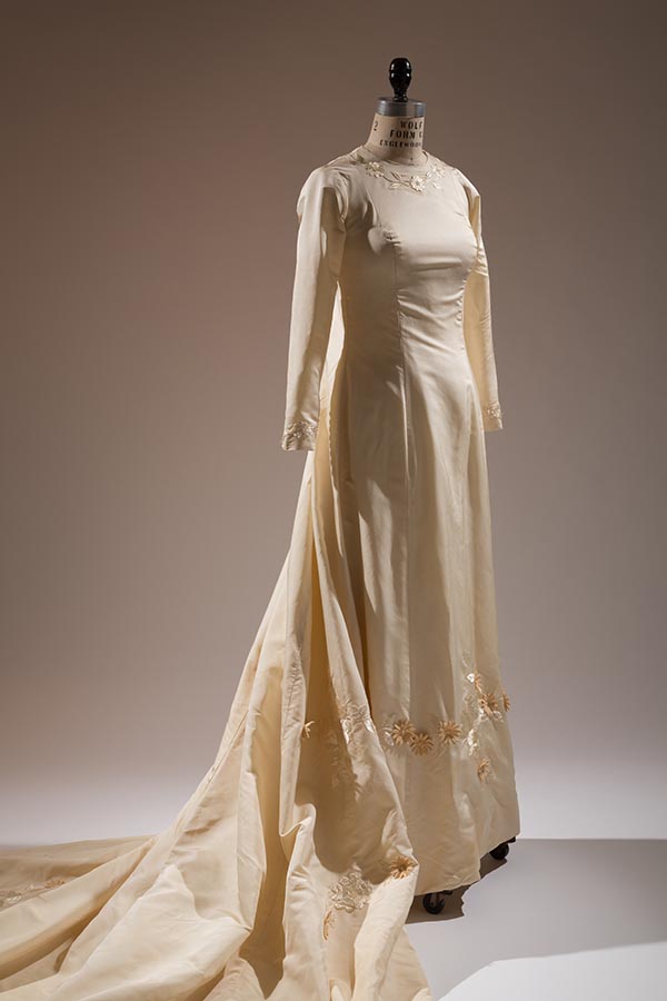off-white wedding gown with long train, embroidered flower and appliqued cotton daisies motif