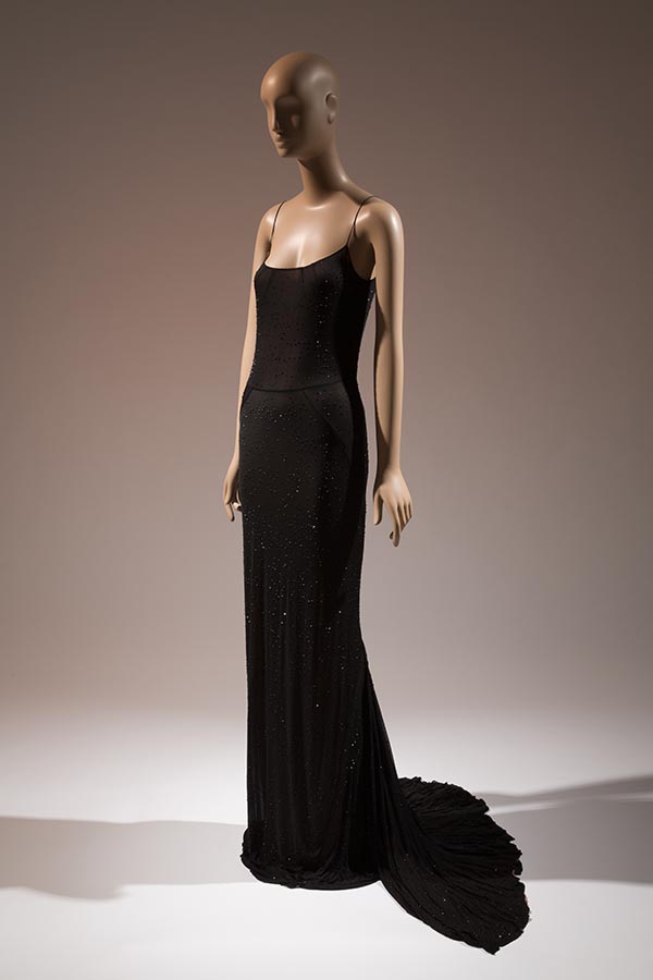 black semi-sheer slip-style dress with nude lining, swarovski crystals, and fishtail back and train