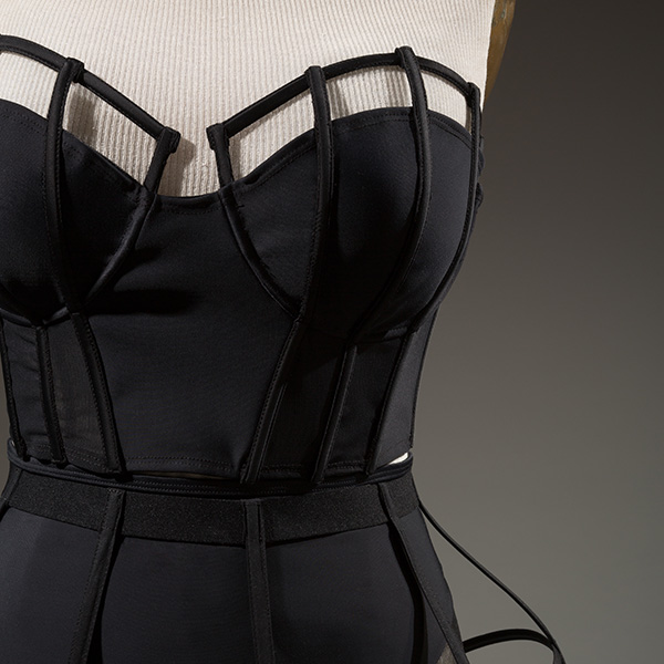 detail of Chromat ensemble made of black plastic boning