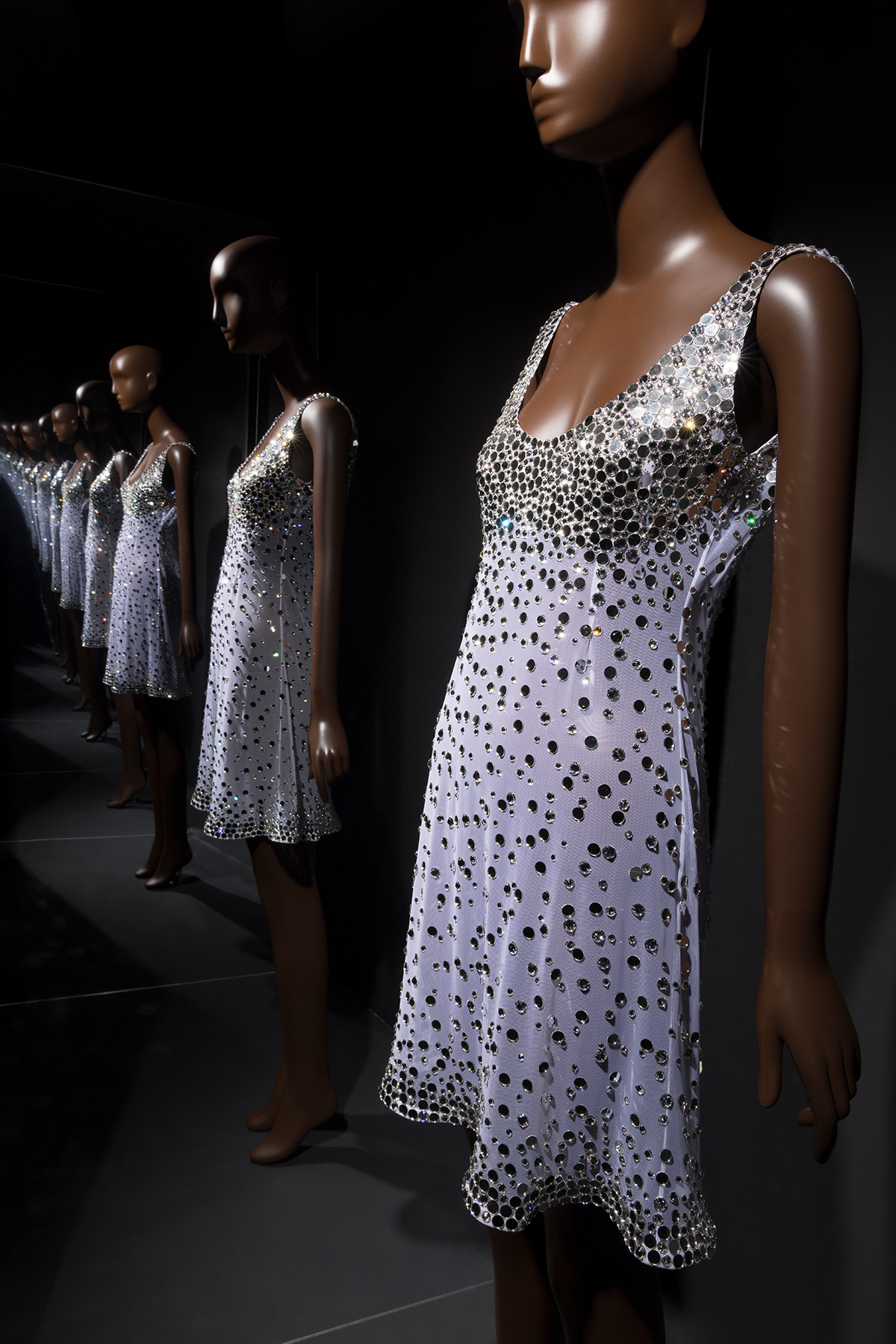 white dress with crystal rhinestones with mirror beads in a reflective chamber 