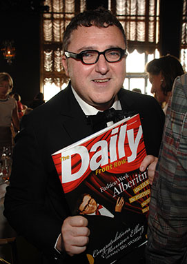 Alber Elbaz smiling while holding a Daily Front Row magazine of Isabel Toledo