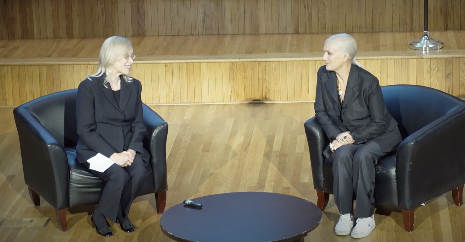 Valerie Steele and Maria Grazia Chiuri in chairs on a stage