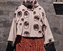 hoodie with printed photos of eyes patched on with red threads