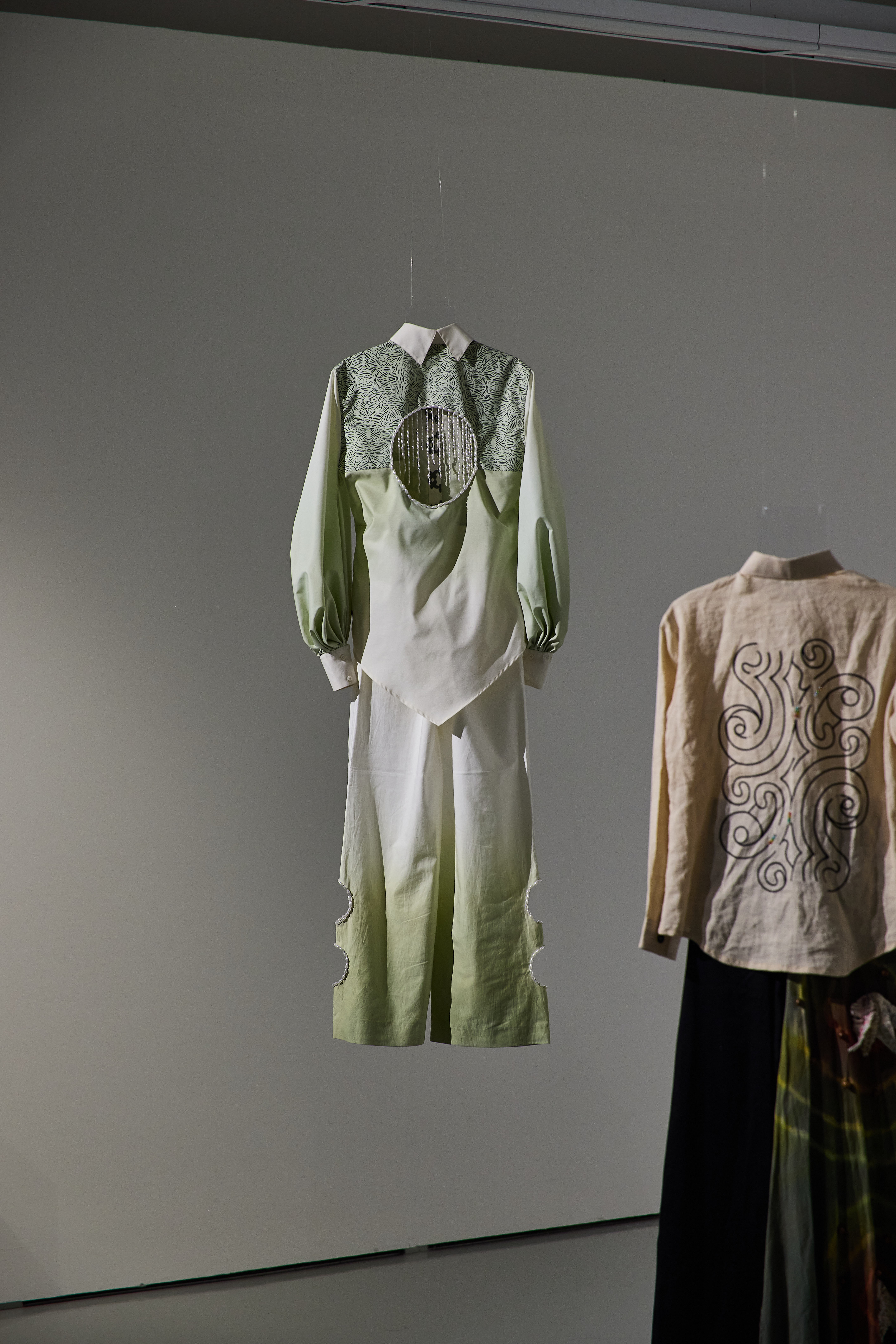 green and white ombre collared top and pant ensemble with green lace details and circular cut out at center chest with beaded fringe