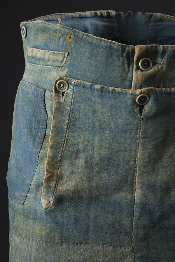 blue repurposed trousers with denim patches and drop front iwht ivory buttons