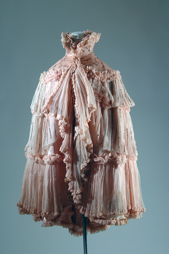 Evening cape in pink silk chiffon with tiers of sequined ruffles edged with ruching