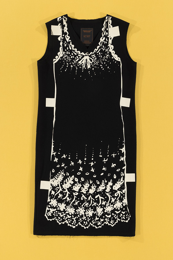 black sleeveless dress with print of a dress with floral prints at the bottom of the scalloped hem, outlined in white with tabs on side 