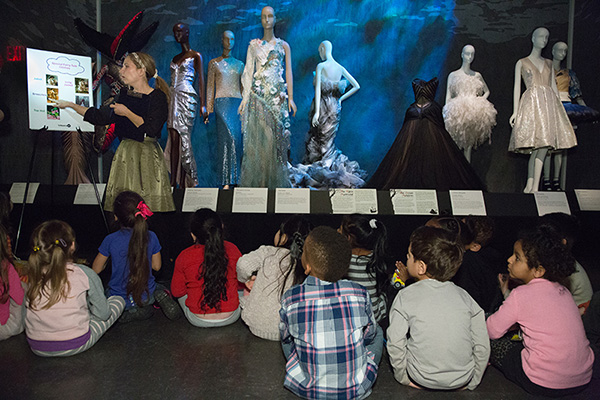 a group children listening to a demonstration in the galleries