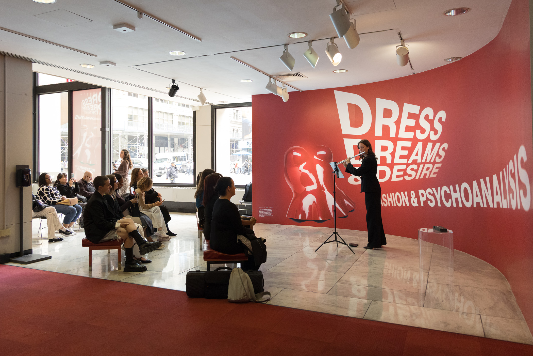 Anna Urrey playing the flute for an audience in the MFIT lobby