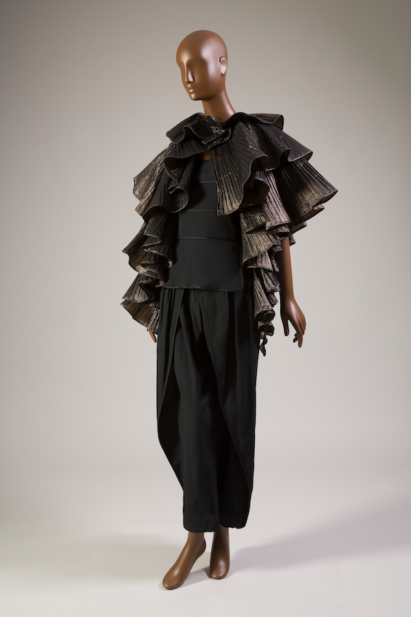 black and metallic pleated tiered cape with black camisole peplum top and tapered pants