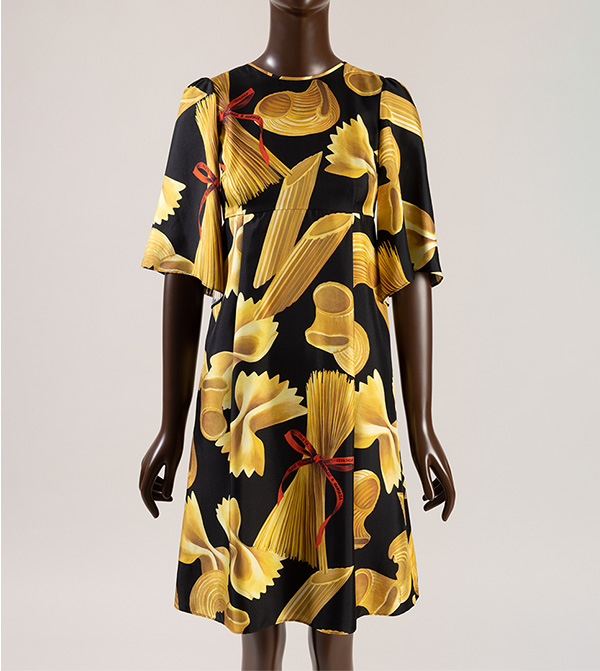 Silk dress with yellow gold penne, farfalle, macaroni and spaghetti pasta print tied with red logo ribbon