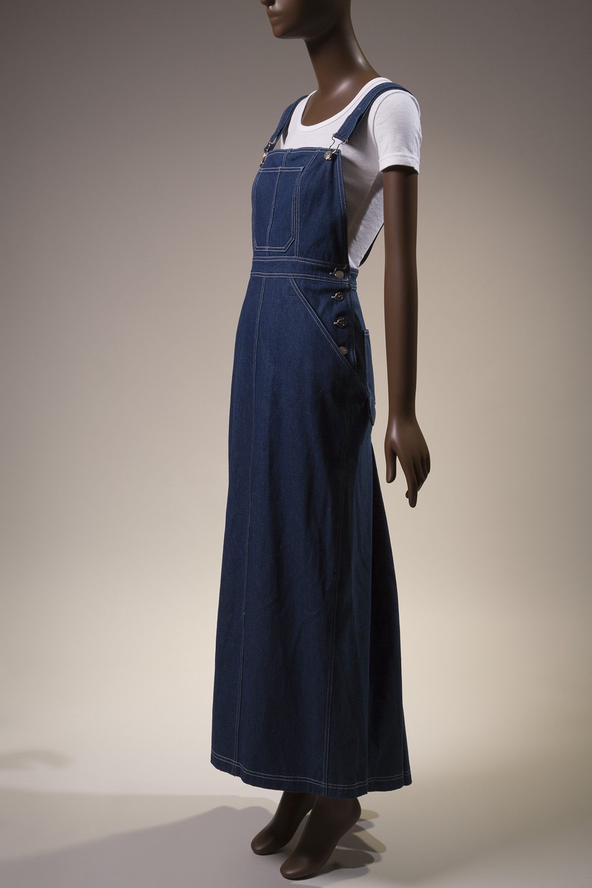 denim overalls dress styled with white cotton shirt