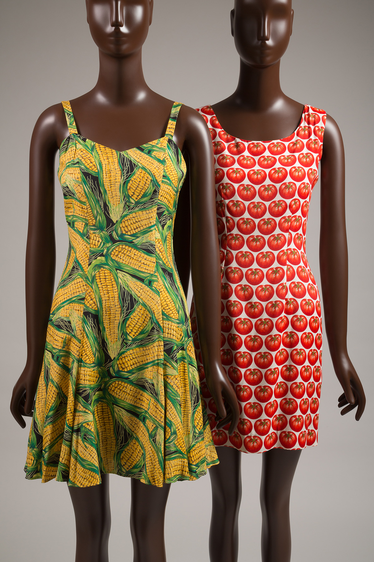 two dresses, one corn printed and one tomato printed