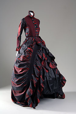 black and burgundry evening dress with large ruffled skirt and a high neck