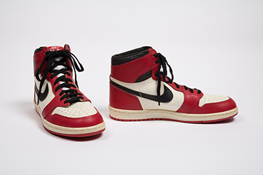 red and white high top sneakers with black nike swoosh