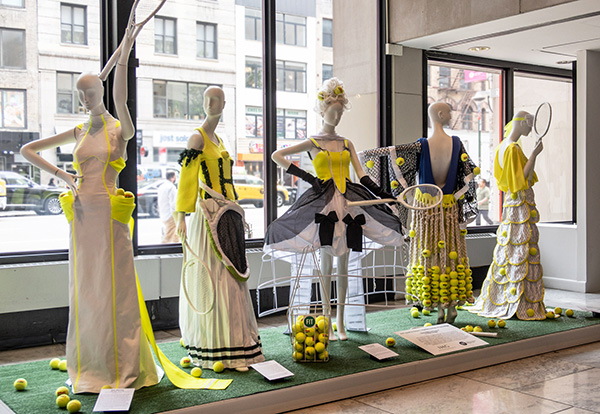 5 white dresses with varying tennis motif designs, incorporating racquets and tennis balls